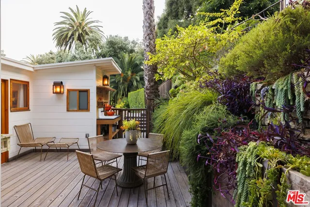 a backyard of a house with table and chairs