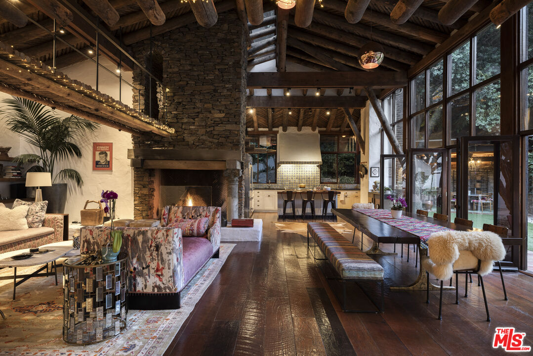 659 East Channel Road Santa Monica, CA 90402 - Photo 3 of 22 a view of a patio with dining table and chairs with a fireplace