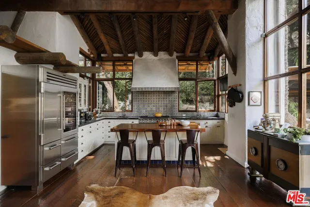 a kitchen with stainless steel appliances granite countertop a stove and a refrigerator