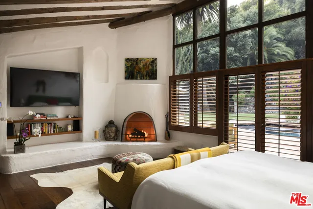 a bedroom with furniture and a flat screen tv