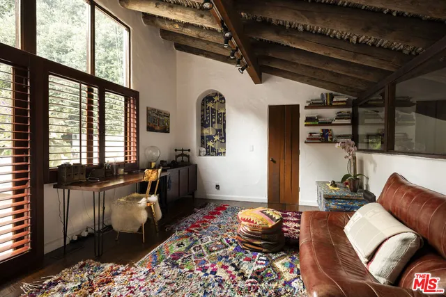 a living room with furniture and a floor to ceiling window