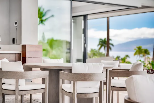 a dining room with furniture and a potted plant