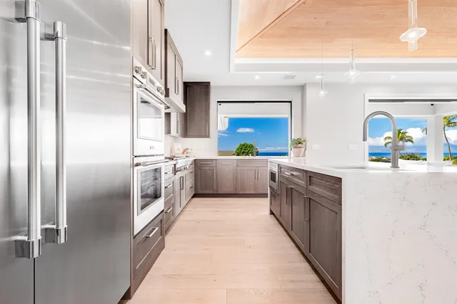 a kitchen with stainless steel appliances a sink and a refrigerator