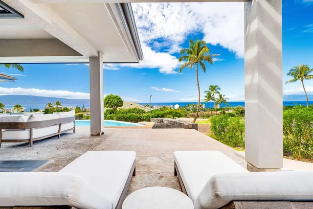a view of a patio with a table and chairs and potted plants