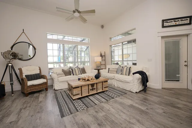 a living room with lots of furniture and a large window