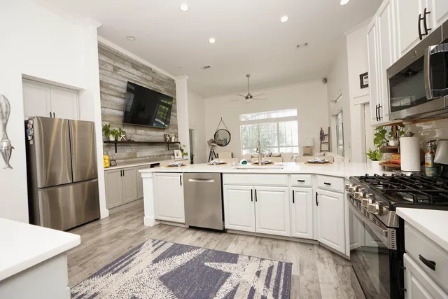 a kitchen with appliances a sink and cabinets