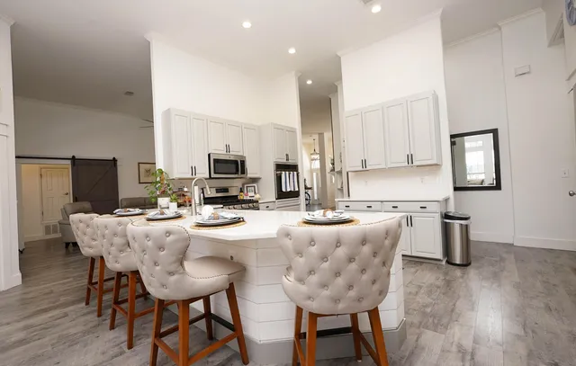 a kitchen with stainless steel appliances kitchen island granite countertop a sink and a stove