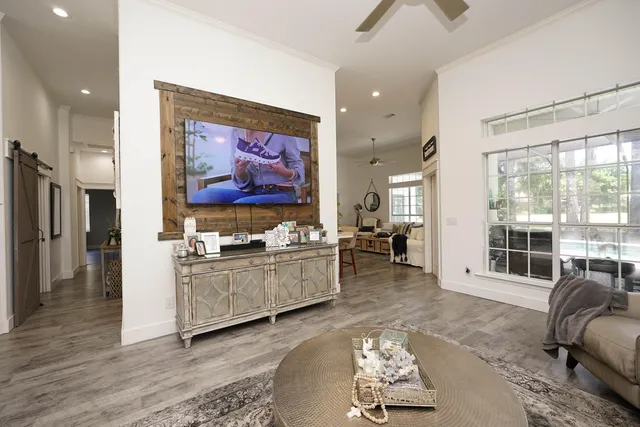 a bedroom with a large bed and wooden floor