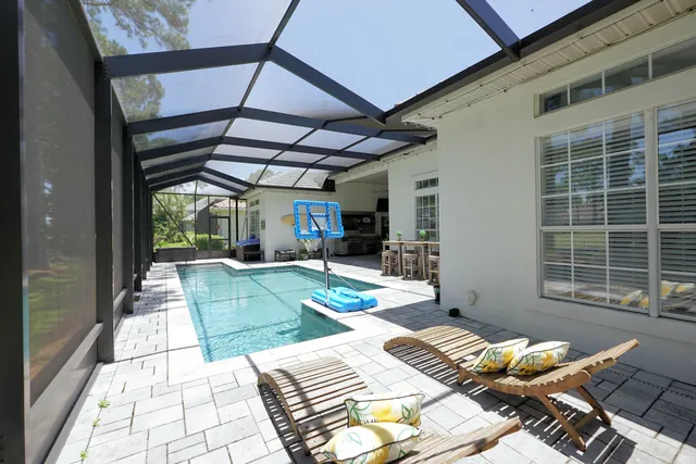 an aerial view of residential houses with outdoor space and trees