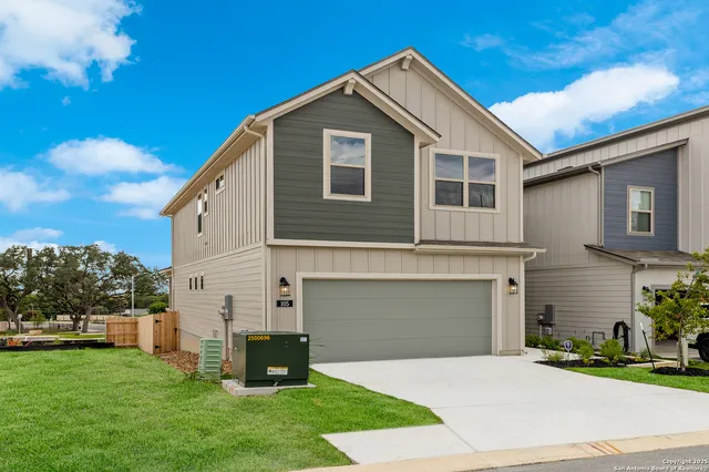 a front view of a house with a garden and yard