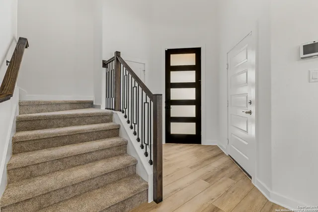 a view of entryway with stairs and wooden floor