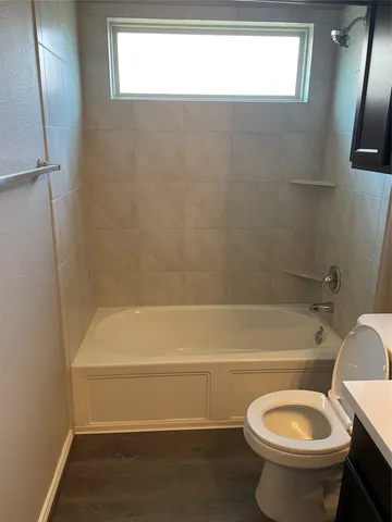 a bathroom with a toilet and a bathtub