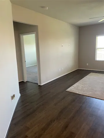 an empty room with wooden floor and closet