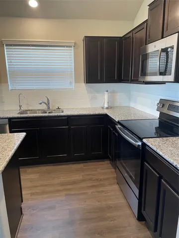 a kitchen with a sink and a stove top oven
