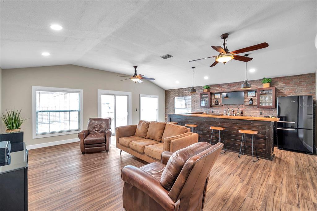 4815 Plantation Drive Tampa, FL 33615 - Photo 11 of 43 a living room with furniture a wooden floor and chandelier