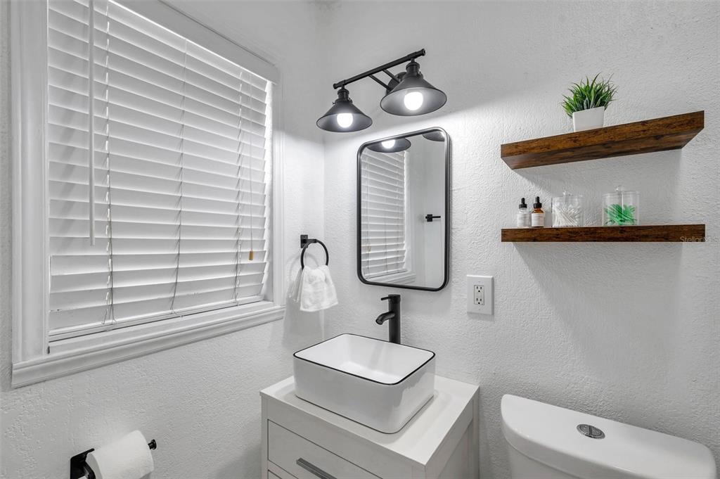 4815 Plantation Drive Tampa, FL 33615 - Photo 24 of 43 a bathroom with a sink toilet and mirror
