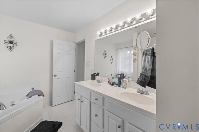 a bathroom with a sink vanity and a mirror