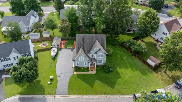 an aerial view of a house with a yard