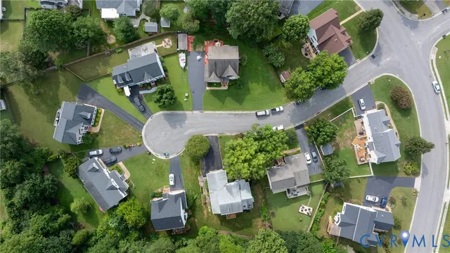 an aerial view of a house with outdoor space and swimming pool