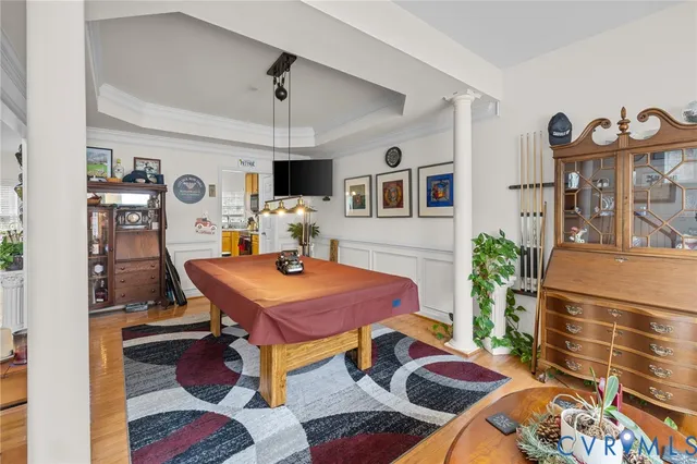 a living room with furniture a flat screen tv and a table
