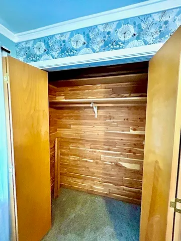 a view of empty room with wooden walls