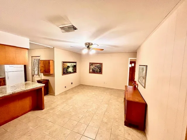 a view of kitchen with refrigerator and window
