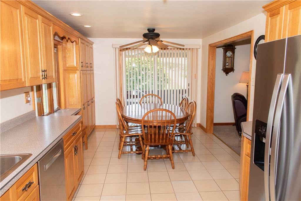 3124 Main Street Aliquippa, PA 15001 - Photo 12 of 30 a dining room with stainless steel appliances a table chairs and a refrigerator
