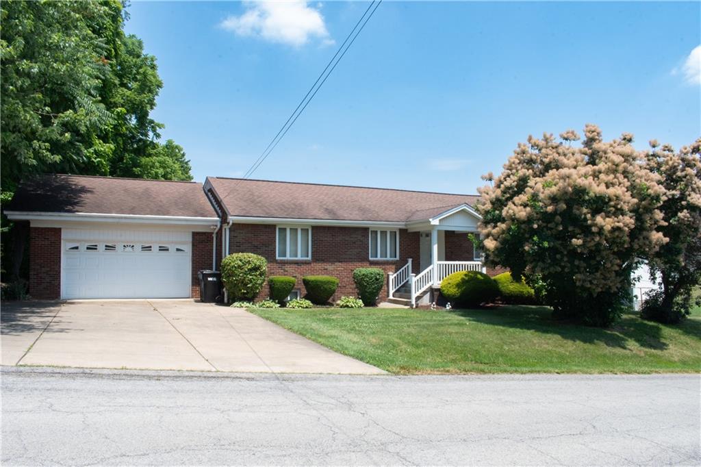 3124 Main Street Aliquippa, PA 15001 - Photo 2 of 30 a front view of a house with a yard and garage
