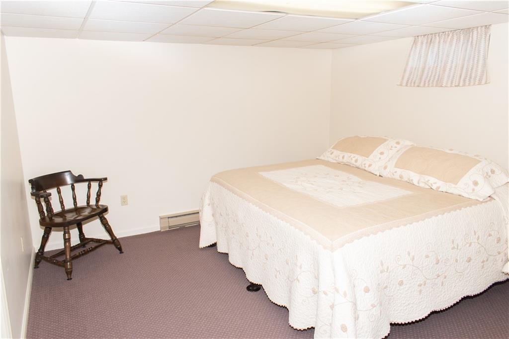 3124 Main Street Aliquippa, PA 15001 - Photo 24 of 30 a spacious bedroom with a bed and a chair