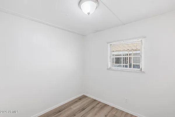 a view of a room with wooden floor
