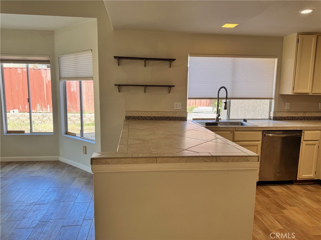 30628 Moontide Court Temecula, CA 92592 - Photo 12 of 53 a kitchen with stainless steel appliances granite countertop a sink a stove and a wooden floors