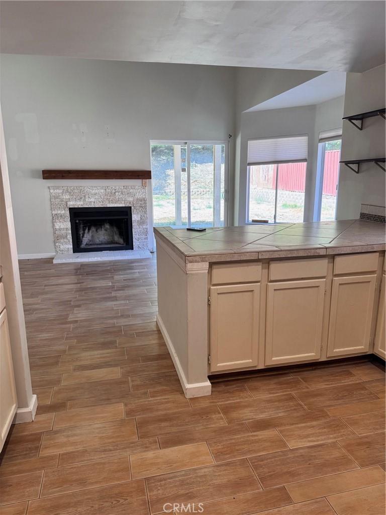 30628 Moontide Court Temecula, CA 92592 - Photo 13 of 53 a kitchen with granite countertop a stove a sink and a fireplace