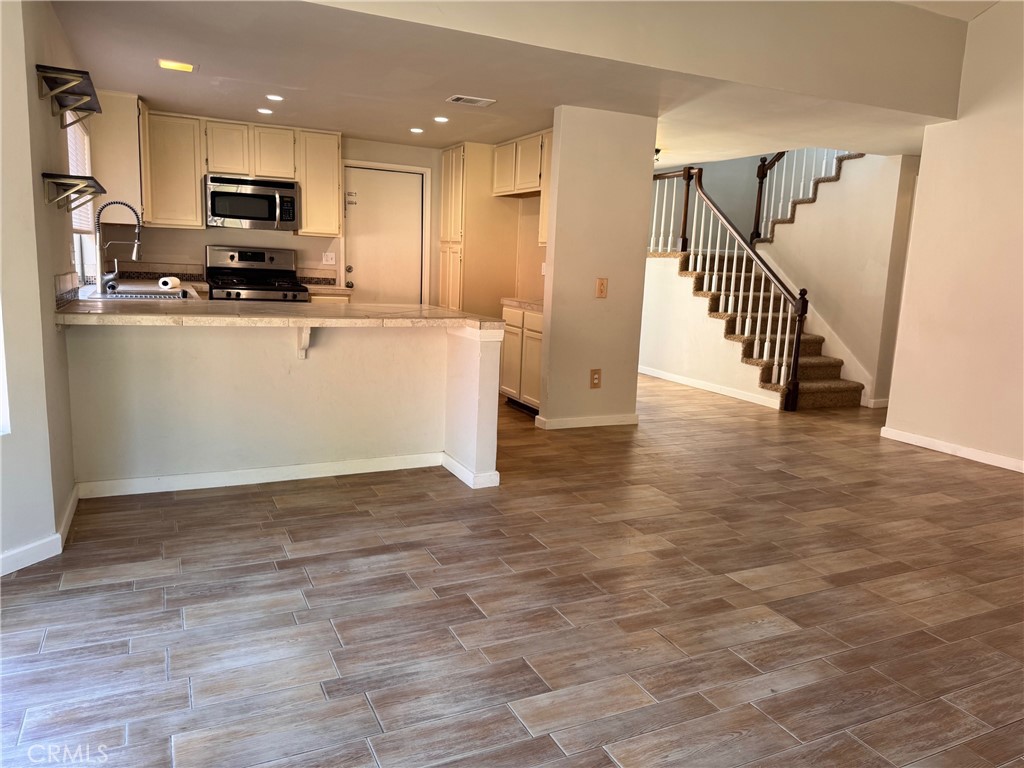 30628 Moontide Court Temecula, CA 92592 - Photo 15 of 53 a view of kitchen with stainless steel appliances granite countertop a stove top oven a sink and a refrigerator