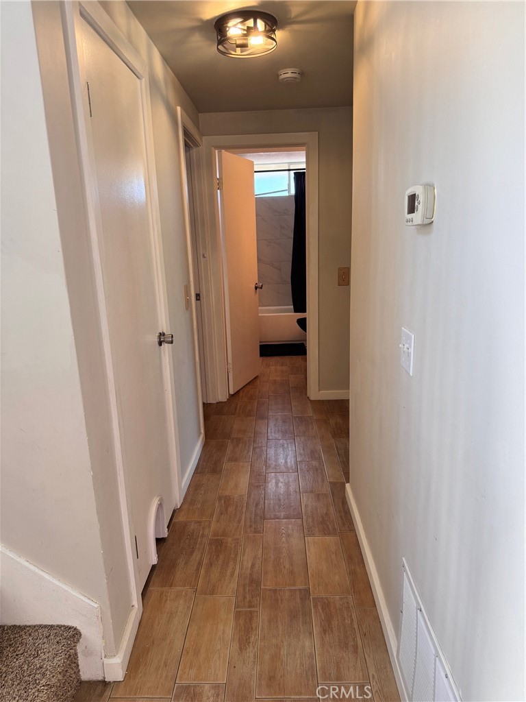 30628 Moontide Court Temecula, CA 92592 - Photo 16 of 53 a view of a hallway with wooden floor and a bathroom