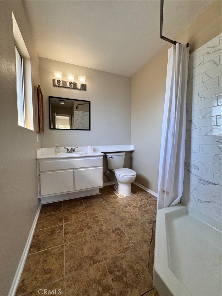30628 Moontide Court Temecula, CA 92592 - Photo 36 of 53 a bathroom with a sink a toilet and mirror