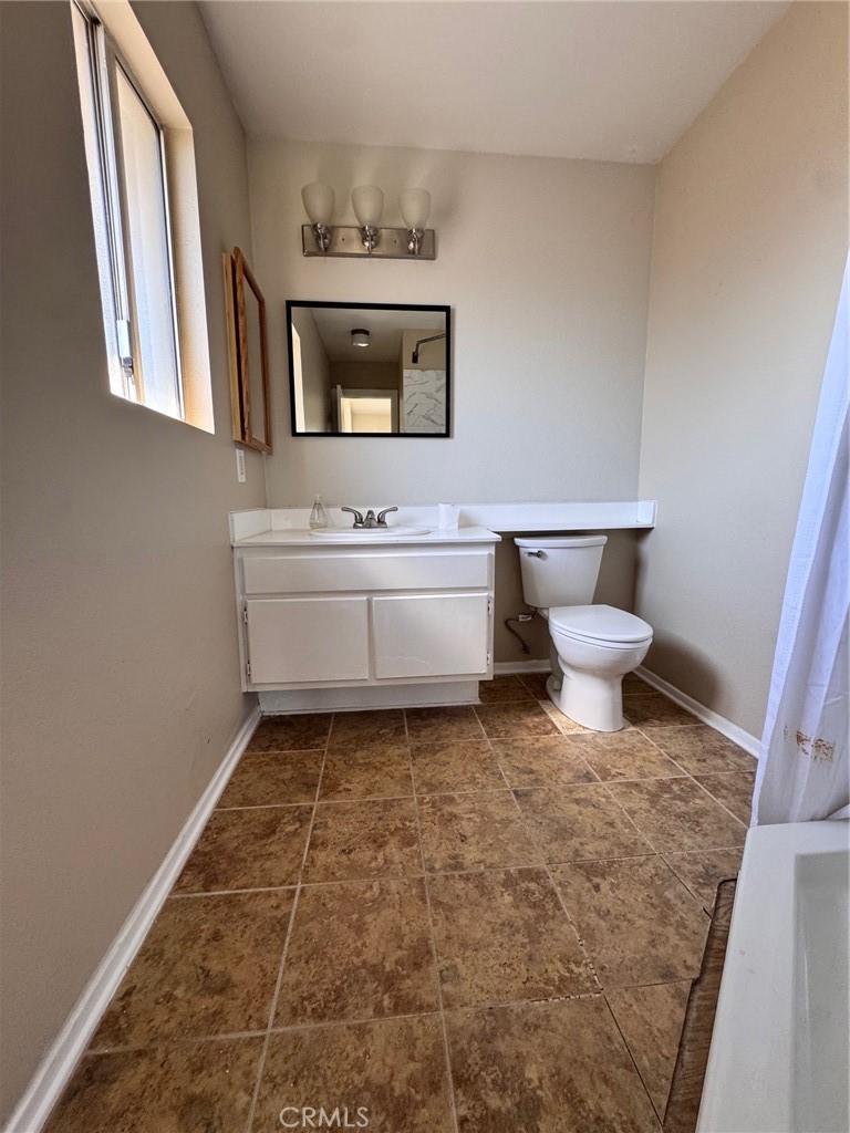 30628 Moontide Court Temecula, CA 92592 - Photo 38 of 53 a bathroom with a toilet sink and mirror
