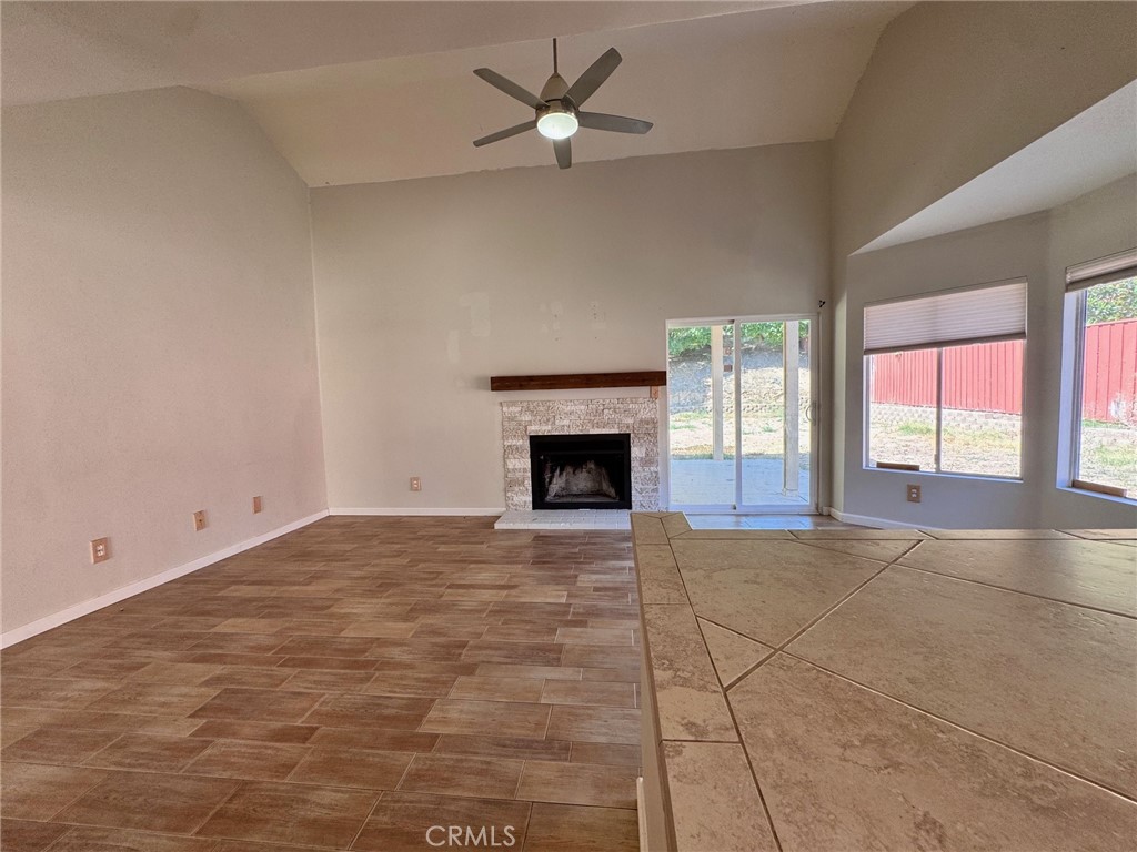 30628 Moontide Court Temecula, CA 92592 - Photo 7 of 53 a view of an empty room with a fireplace and a window