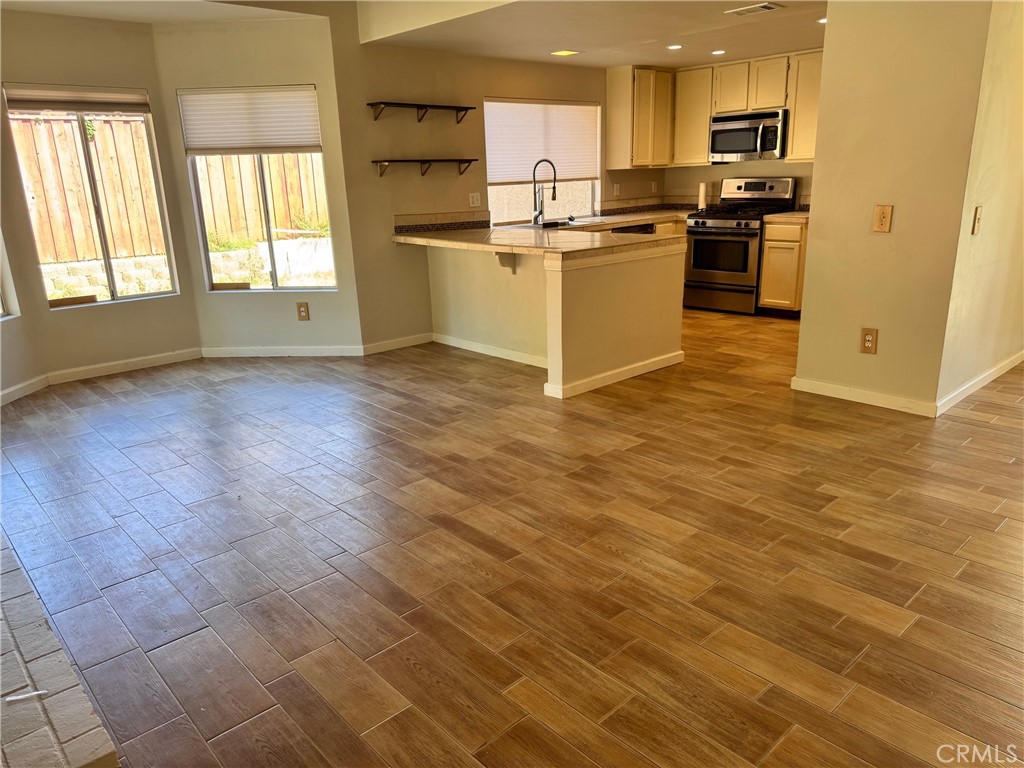 30628 Moontide Court Temecula, CA 92592 - Photo 8 of 53 a kitchen with granite countertop a stove a sink and a refrigerator