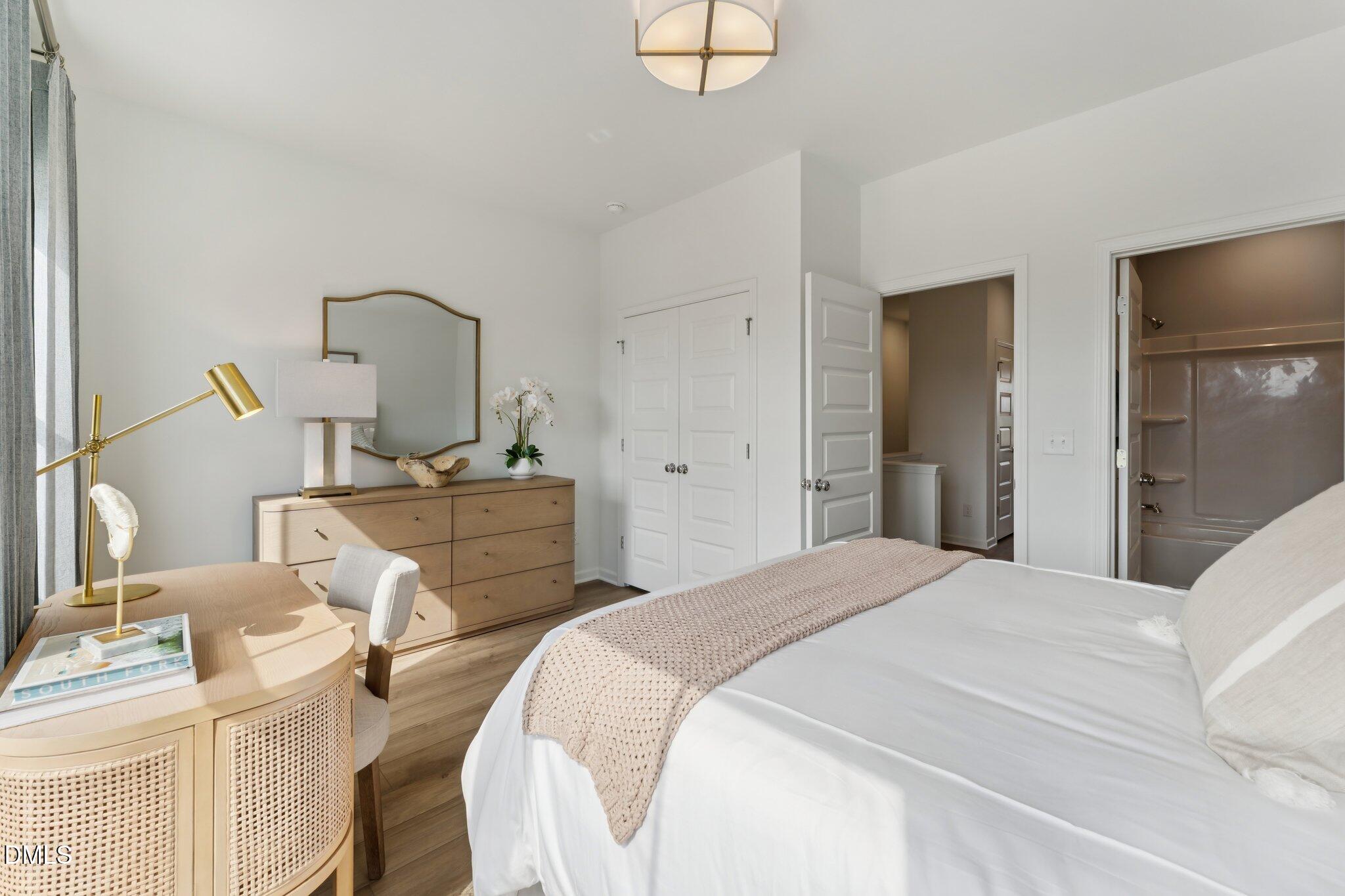 3204 Bomore Road Raleigh, NC 27610 - Photo 21 of 33 a bedroom with a bed and a chandelier