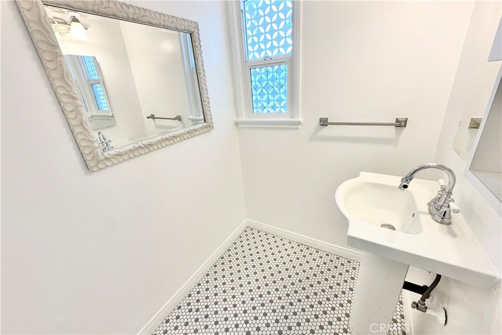 4290 Oakwood Place Riverside, CA 92506 - Photo 11 of 41 a bathroom with a sink a mirror and a window
