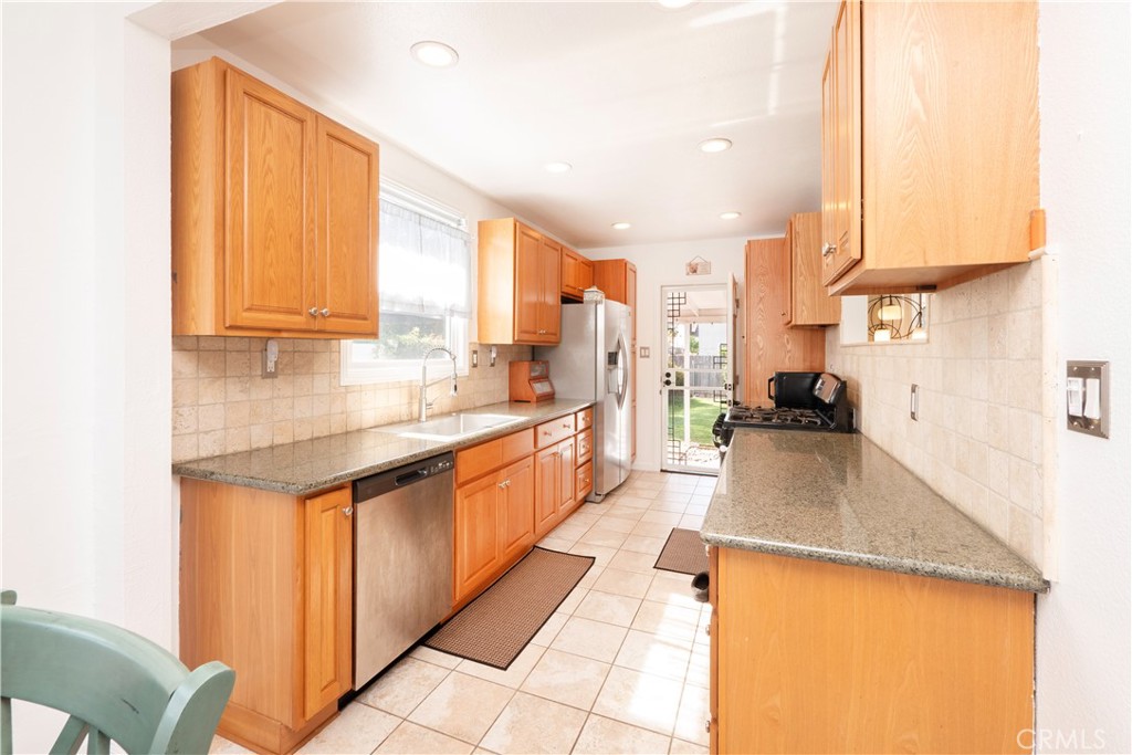 4290 Oakwood Place Riverside, CA 92506 - Photo 25 of 41 a kitchen with stainless steel appliances granite countertop a sink a counter top space and cabinets