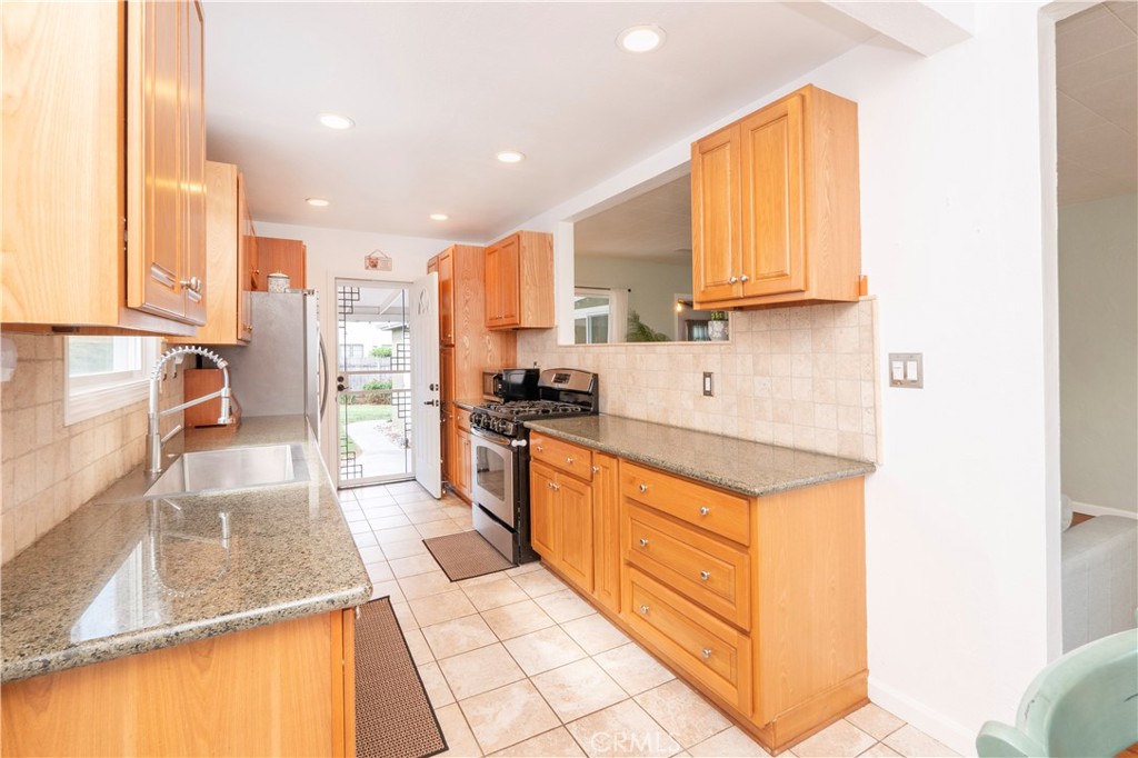 4290 Oakwood Place Riverside, CA 92506 - Photo 26 of 41 a kitchen with stainless steel appliances granite countertop a sink stove and cabinets