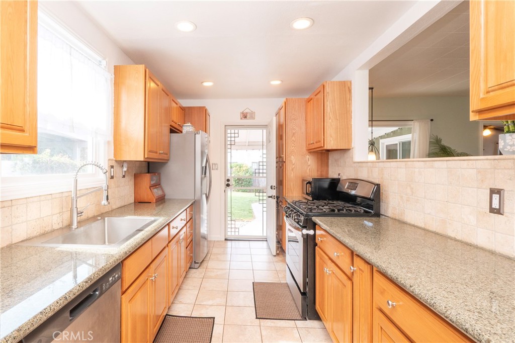 4290 Oakwood Place Riverside, CA 92506 - Photo 4 of 41 a large kitchen with stainless steel appliances granite countertop a sink stove and refrigerator