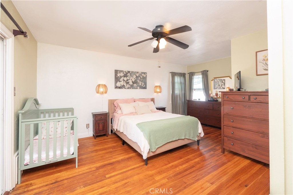 4290 Oakwood Place Riverside, CA 92506 - Photo 7 of 41 a bedroom with a bed and wooden floor