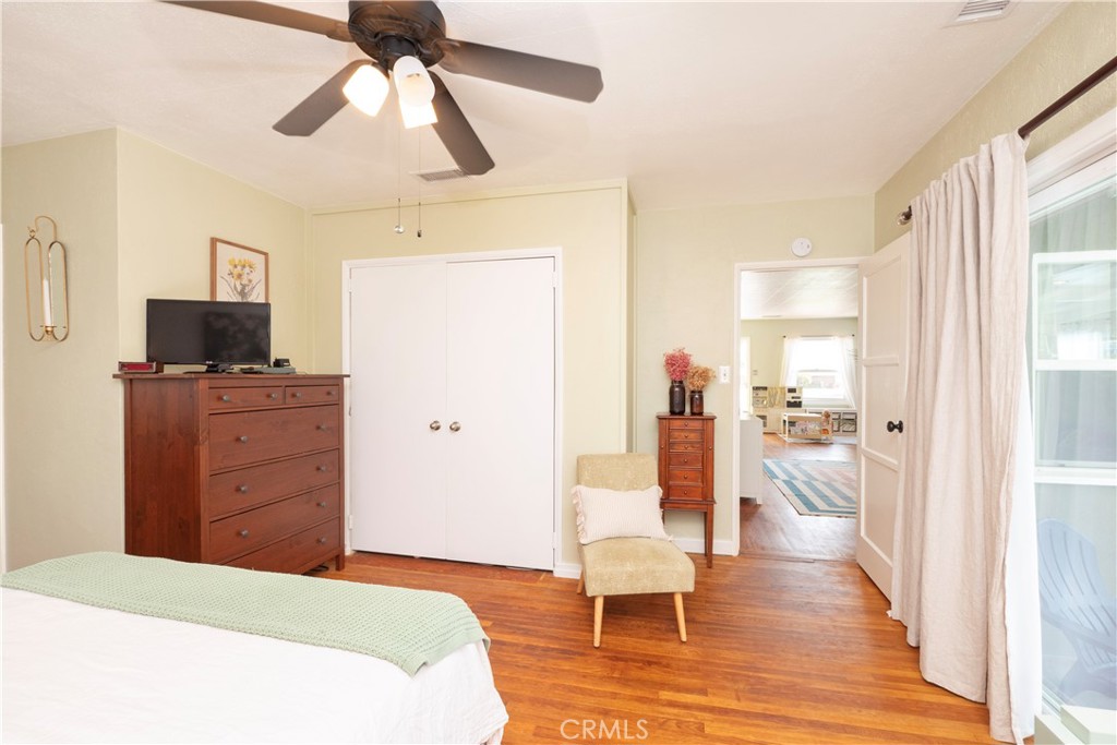 4290 Oakwood Place Riverside, CA 92506 - Photo 8 of 41 a bedroom with a bed and wooden floor