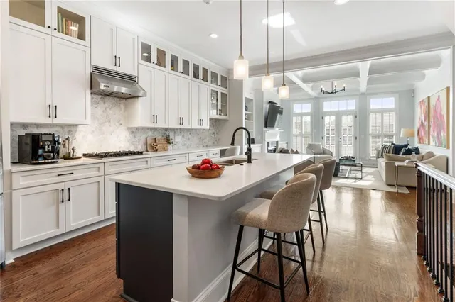 a kitchen with stainless steel appliances kitchen island granite countertop a sink and cabinets