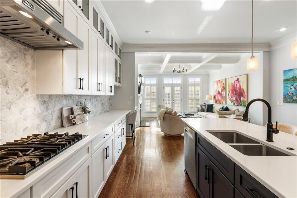 3611 Habersham Road Northwest Atlanta, GA 30305 - Photo 13 of 44 a kitchen with stainless steel appliances a sink a stove top oven a counter space and cabinets