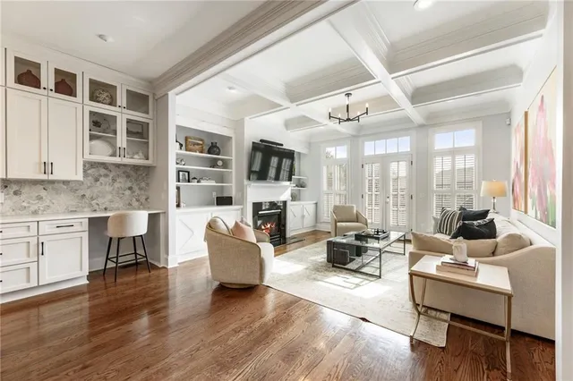 a living room with fireplace furniture and a wooden floor