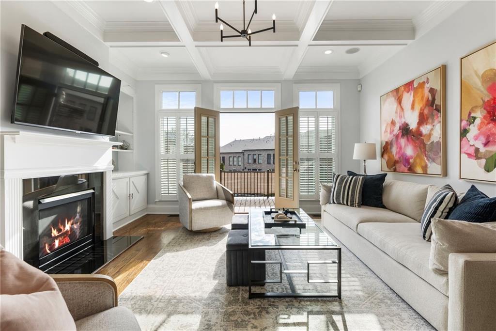 3611 Habersham Road Northwest Atlanta, GA 30305 - Photo 19 of 44 a living room with furniture a flat screen tv and a fireplace