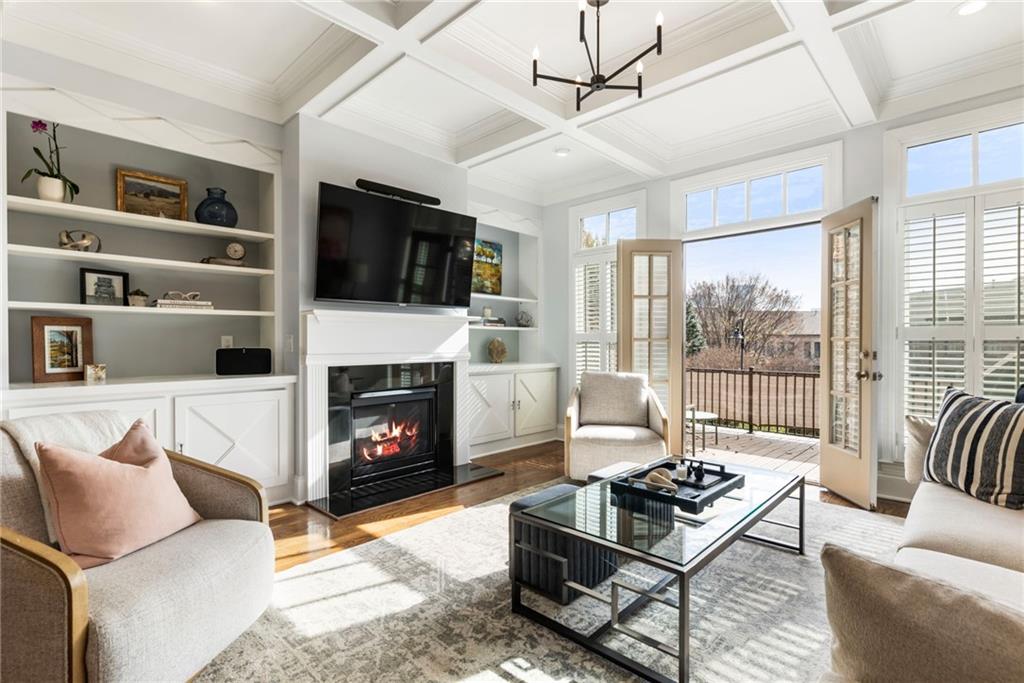3611 Habersham Road Northwest Atlanta, GA 30305 - Photo 20 of 44 a living room with furniture a flat screen tv and a fireplace